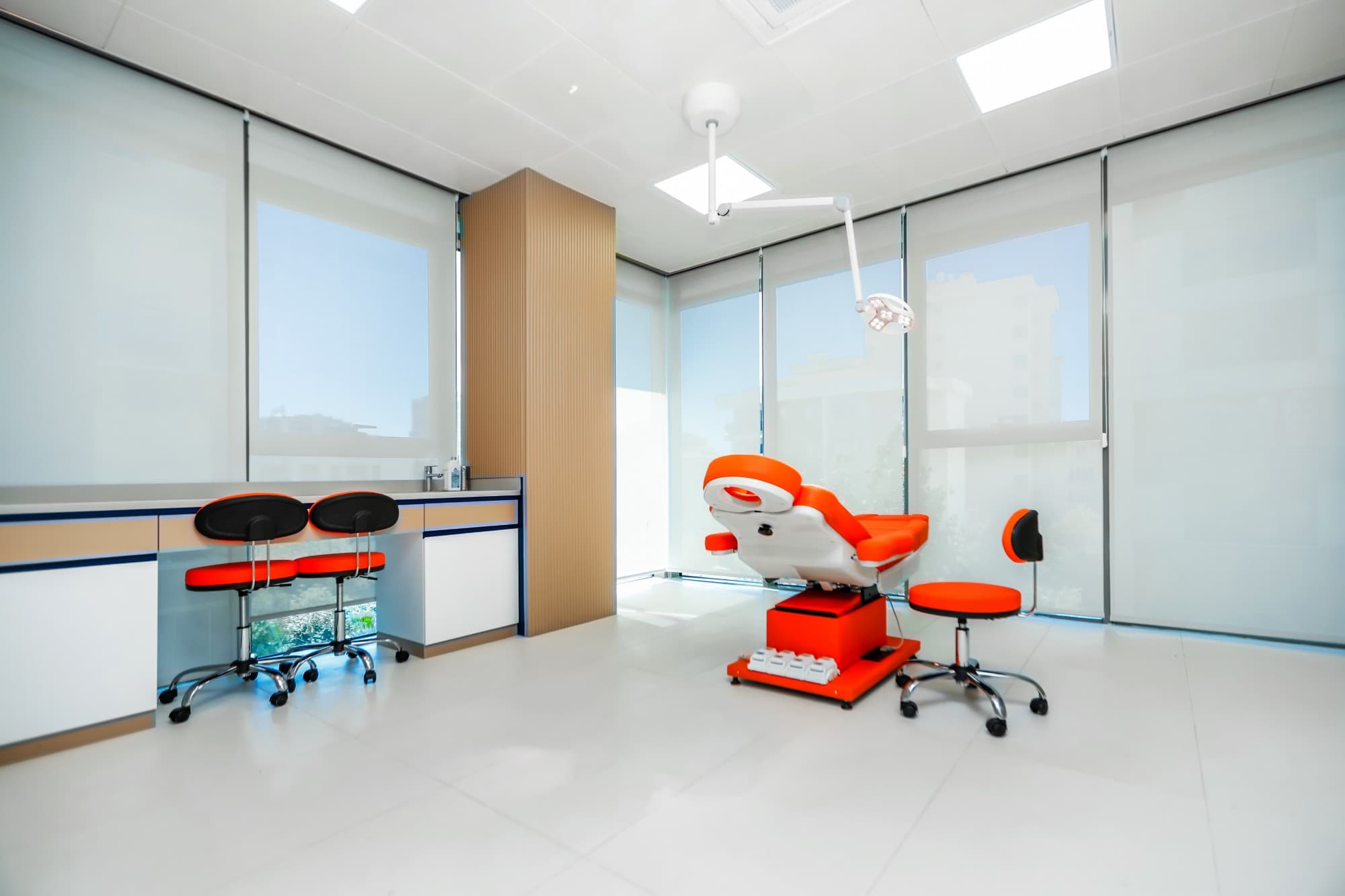 Renewa Clinic treatment room with an orange examination chair and daylight windows