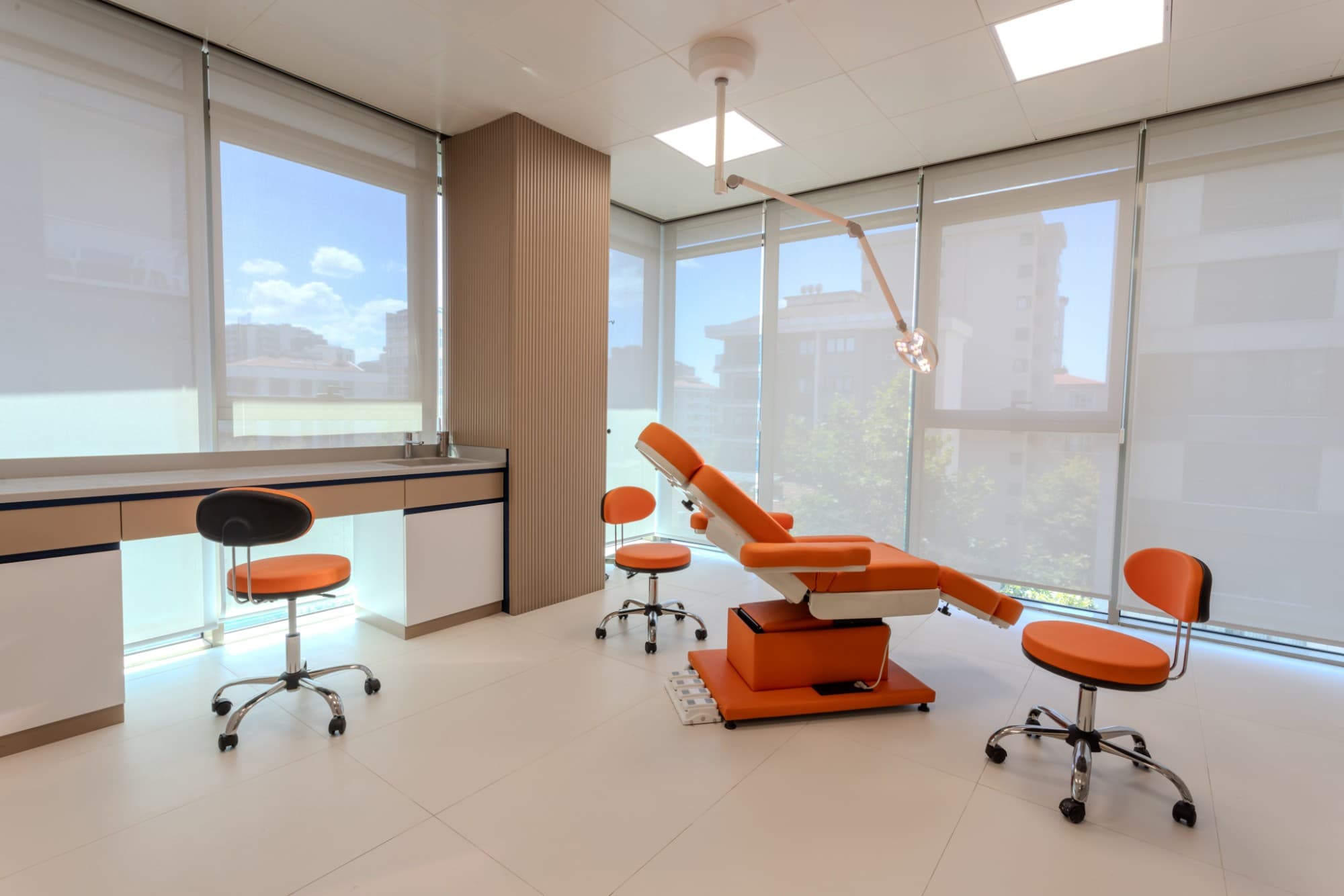 Renewa Clinic treatment room with an orange chair overlooking the city